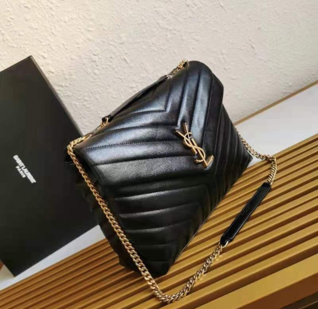 Yves Saint Laurent Loulou Toy preta, em pele matelassé, com ferragens douradas envelhecidas.